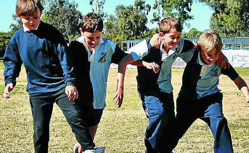 Warwick East students (from left) Nicolas Williams, Kyle Piovesan, James Walker and Angus McKay prepare for the three legged race, as other students generations before them did decades ago. Warwick East students (from left) Nicolas Williams, Kyle Piovesan, James Walker and Angus McKay prepare for the three legged race, as other students generations before them did decades ago.